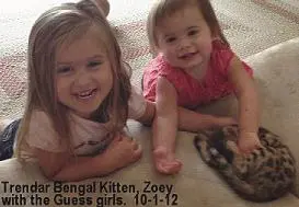 Two little girls laying on the floor together