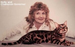 Woman with a Bengal cat on table.